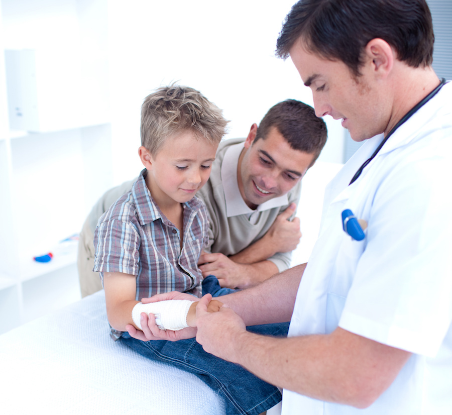 Doctor bandagins a patient's arm in hospital